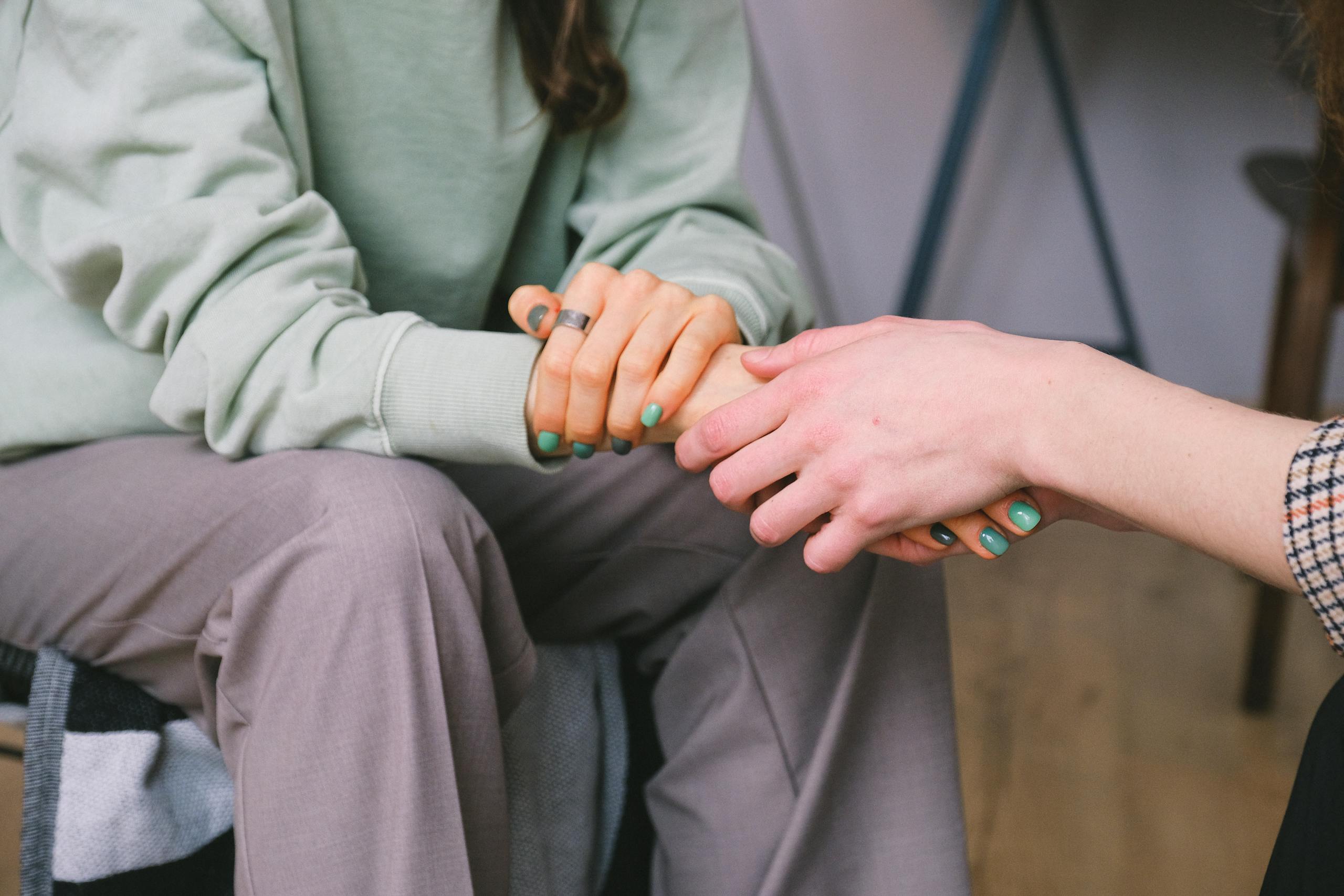 Crop psychologist supporting patient during counseling indoors