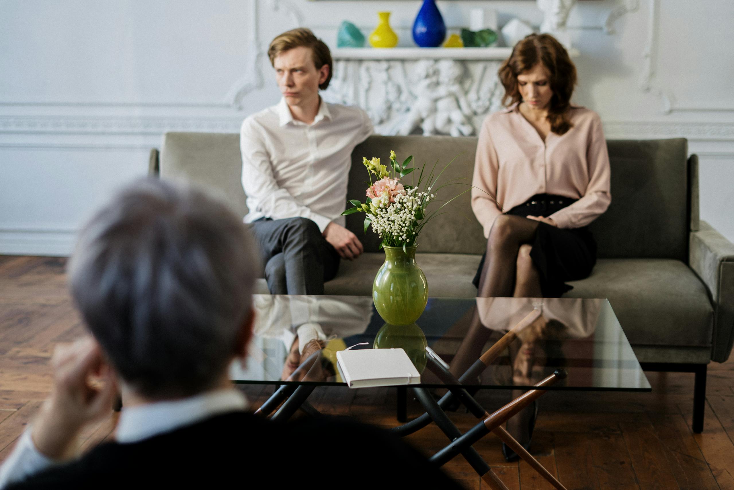 Woman in White Long Sleeve Shirt Sitting Beside Woman in White Long Sleeve Shirt